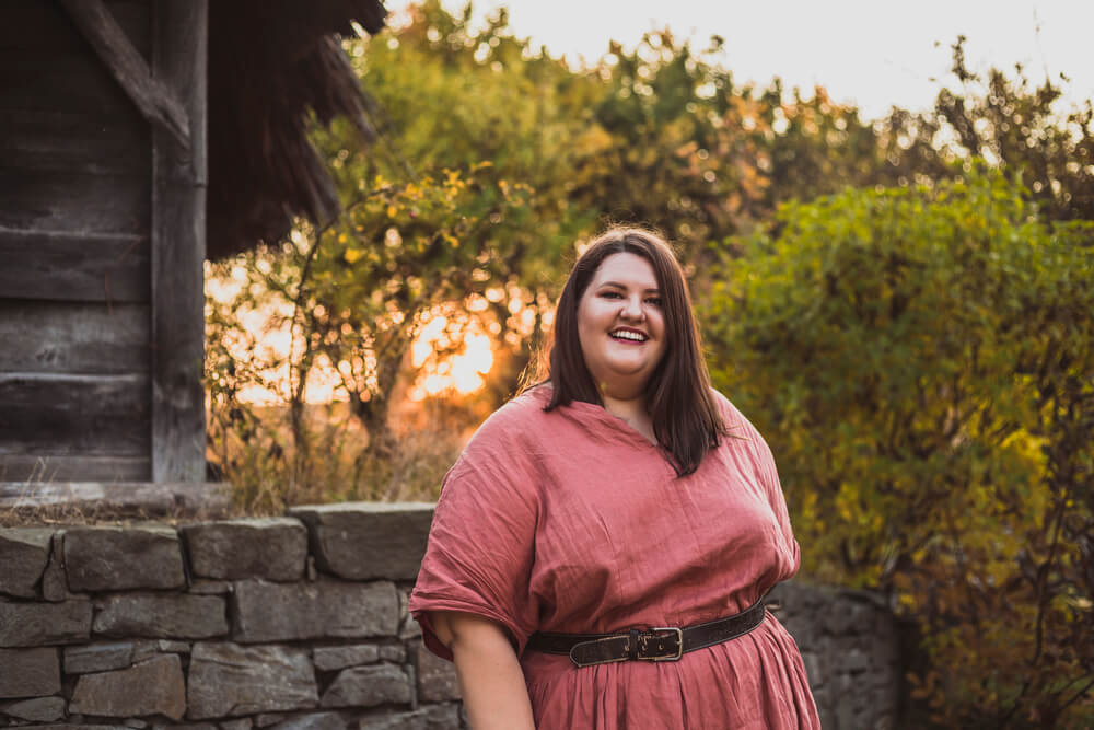 Happy woman at sunset in red dress